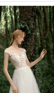 Detail of floral embroidery and sequins on the off-shoulder bodice of this bridal gown