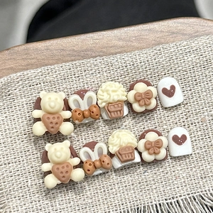 Handmade 3D press-on nails for kids featuring cute mocha brown bears and cream bows