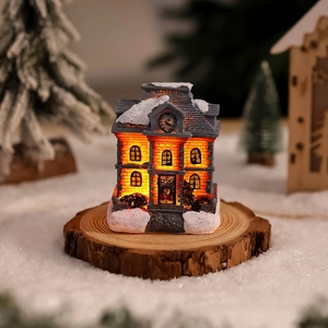 Luminous resin Christmas house ornament with grey pointed roof and warm LED lighting