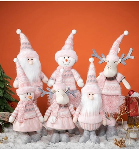 Group of plush Santa, snowman and reindeer dolls on warm background with snow effect
