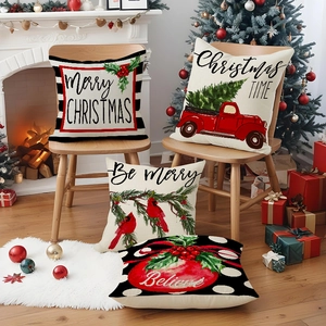 Set of four Christmas linen pillow covers with red truck and holly designs near a fireplace