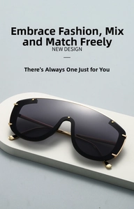 Detailed view of oversized shield sunglasses with gold rivets and slim metal temples