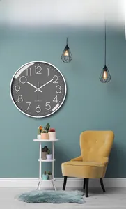 Macro shot of 12-inch silent wall clock with white 3D numbers on a dark grey dial