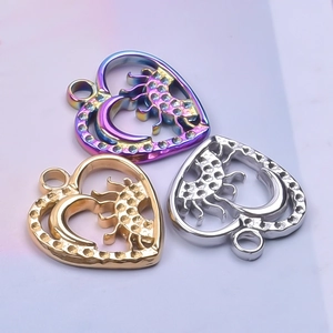Detailed close-up of heart-shaped sun and moon pendants in gold, silver and purple finish