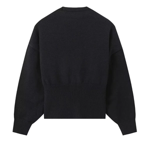 Detail of black knit cardigan featuring dropped shoulders and wide ribbed hem on back