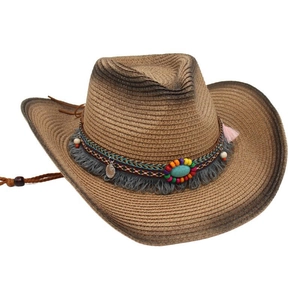 Detail of western straw cowboy hat with colorful beads, turquoise, and ethnic tassels