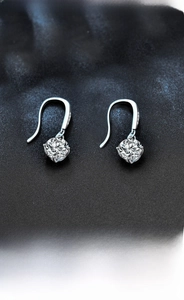 Close-up of S925 sterling silver drop earrings featuring brilliant cut moissanite stones