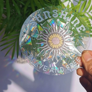 Macro shot of a holographic sunflower suncatcher sticker with rainbow light effects