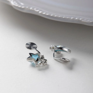 Detail of blue star clip-on earrings with pearls and screw back adjustment