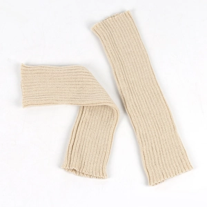 Detailed view of beige chunky knit leg warmers showing thick wool texture and stitching