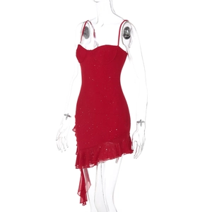 Detail of red slim fit sequin dress showing corset bodice and ruffled asymmetric hemline