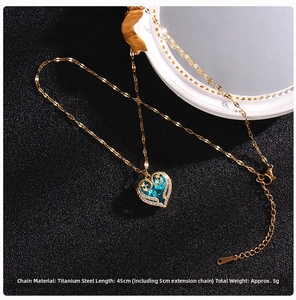 Detail of blue crystal heart pendant with gold titanium steel chain and lobster clasp
