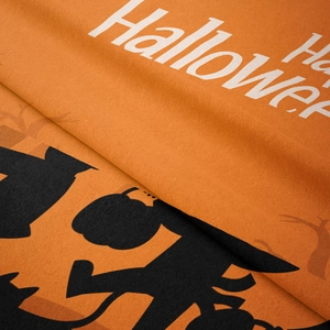 Detail view of Halloween fabric featuring soft velvet texture and vibrant pumpkin prints