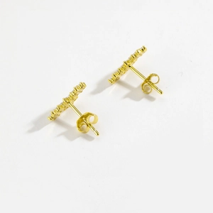 Macro shot of gold S925 sterling silver flower earrings with sparkling zircon crystals
