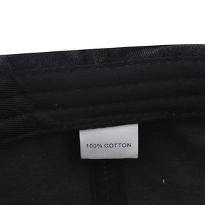Detailed macro view of 100% cotton fabric material label inside the vintage baseball cap