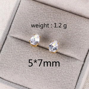 Macro detail of 5x7mm teardrop zircon stud earrings in a premium gray velvet jewelry box