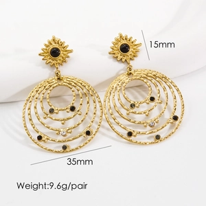 Detail view of 14K gold bohemian earrings with 35mm concentric rings and crystal inlay