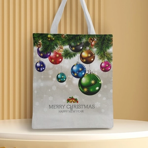 Detailed view of canvas tote bag with Christmas festive prints and white handles