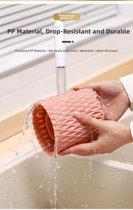 Detailed view of pink wavy PP material organizer being washed under running water