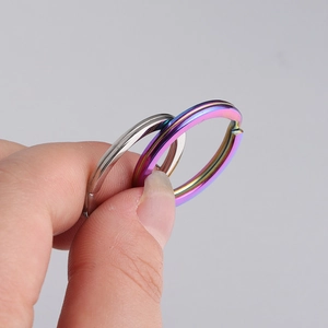 Close-up of polished stainless steel key rings in silver and iridescent rainbow finish