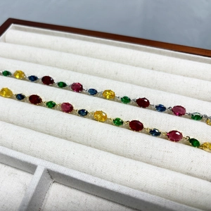 Detail of colorful oval-cut zircon necklaces with gold and silver claw settings