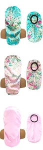 Detail view of long satin sleep caps in floral and solid pink with elastic wide bands
