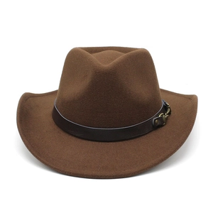 Detailed view of brown felt cowboy hat featuring leather band and bronze buckle