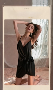Detail of black satin nightgown with deep V-neckline and elegant waist tie ribbon