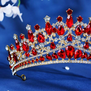 Macro shot of baroque crown featuring red rubies and crystals on gold alloy frame