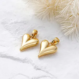 Polished 18K gold plated heart charms for DIY jewelry making on white stone