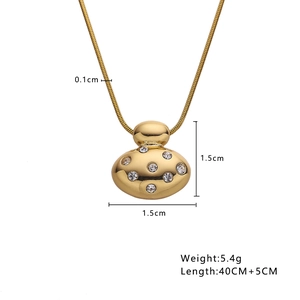 Detail view of gold heart pendant with dimensions 1.5cm by 1.5cm and thin chain