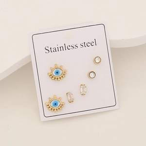 Detail view of gold stainless steel stud earring set with blue evil eye and zircons