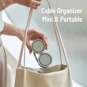 Minimalist grey silicone cable organizer for neck fans inside a beige leather tote bag