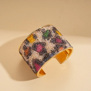 Dettaglio di cristalli leopardati e lega placcata oro sul bracciale di lusso