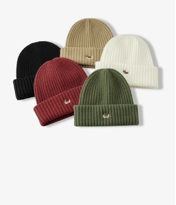 Close-up of five colorful knitted beanies with cute corgi dog embroidery in various shades