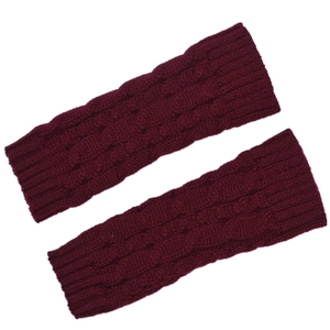 Close-up of wine red cable knit arm warmers showing detailed texture and soft yarn