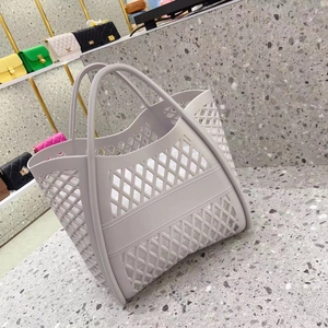 Close-up of a hollowed-out mauve silicone beach bag on a terrazzo surface