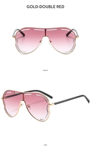 Détail de lunettes de soleil oversize dorées avec verres dégradés rouges et haut évidé