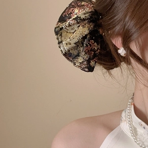 Detail of floral embroidery bow hair tie with traditional Chinese style jacquard fabric