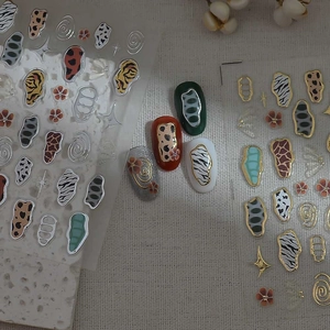 Retro animal print nail stickers featuring leopard and zebra patterns with gold metallic accents