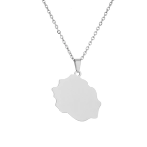 Macro shot of Reunion Island map pendant necklace in polished silver stainless steel