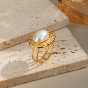 Macro detail of 18K gold-plated lava texture ring with a large oval white pearl