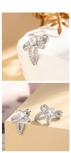Macro shot of silver bow knot earrings with heart cubic zirconia and screw backs