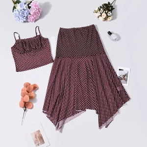 Flat lay of burgundy polka dot mesh two-piece set with camisole and asymmetric skirt