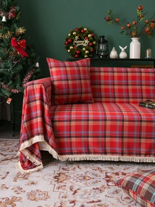 Detail of red and blue checkered sofa throw with tassels and matching pillowcase