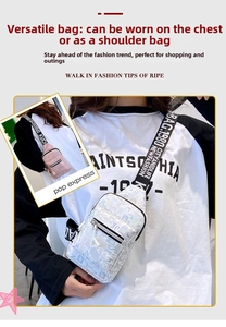 Detail of silver crossbody chest bag with letter prints and decorative triangle pendant