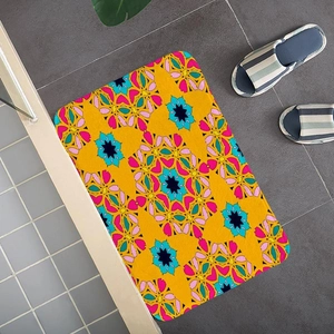 Close-up of yellow rectangular floor mat with bohemian floral geometric patterns on tiles