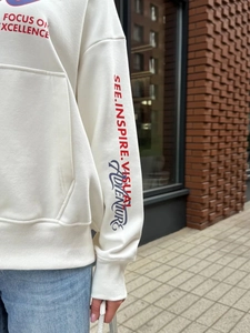 Off-white oversized streetwear hoodie with bold blue and red focus-themed graphic prints