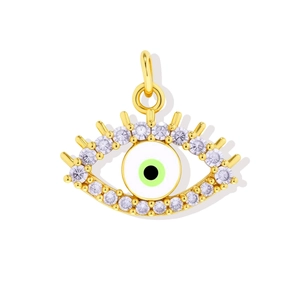 Detail of 18K gold plated evil eye pendant with white zircon and green enamel inlay