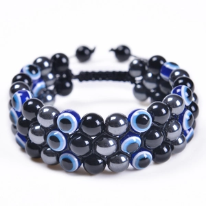 Detailed close-up of triple-layered braided evil eye bracelet with natural tiger eye beads